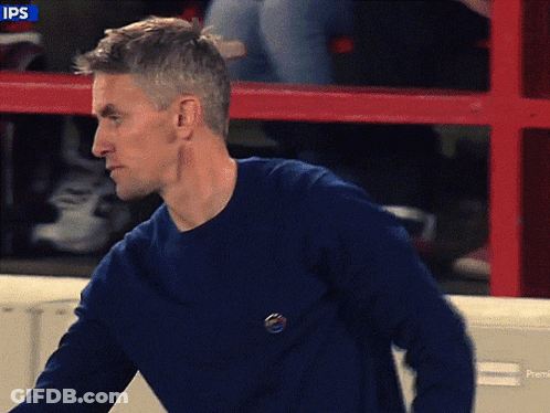 Man In Blue Sweater Red Fence Saying Ips GIF
