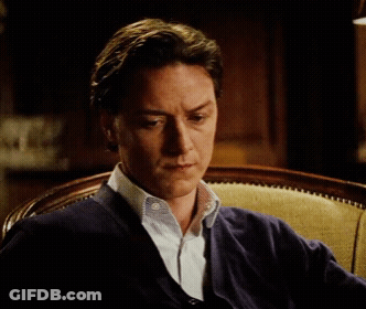 Man In Blue Sweater Sitting Seriously GIF