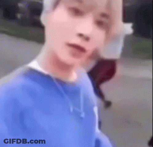 Man In Blue Sweater Taking Selfie While Walking GIF