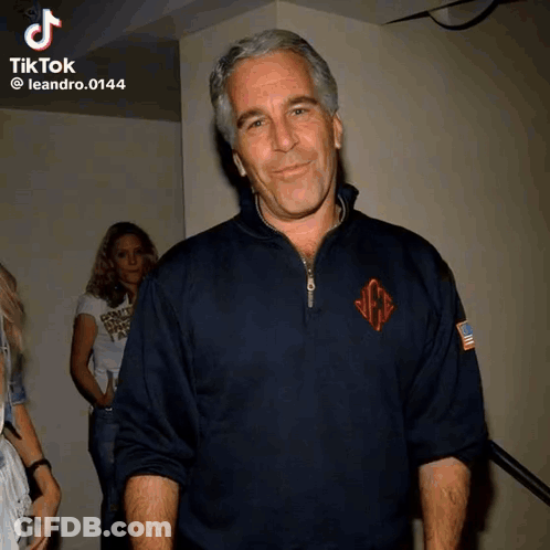Man In Blue Sweater With Monogram GIF