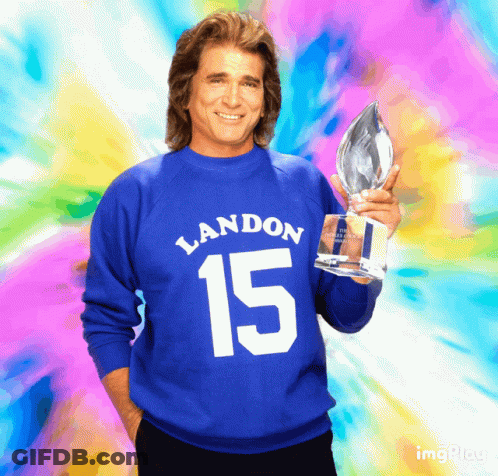 Man In Blue Sweater With Number 15 Holding Trophy GIF