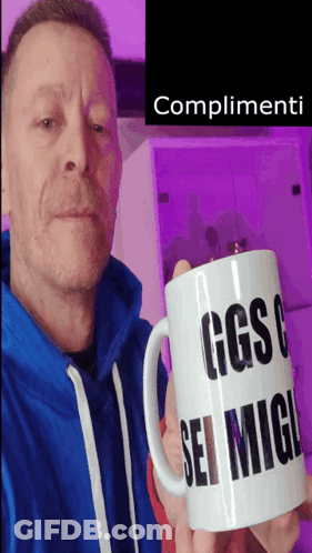 Man In Blue Sweatshirt Holding Mug Saying Complimenti GIF