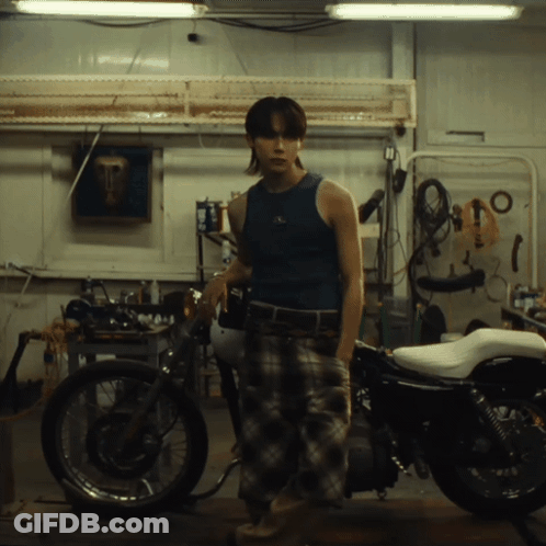 Man In Blue Tank Top In Front Of Motorcycle GIF