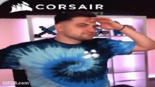 Man In Blue Tie Dye Shirt In Front Of Corsair Logo GIF
