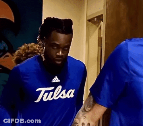 Man In Blue Tulsa Shirt Standing Next To Another Man GIF