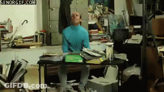 Man In Blue Turtleneck At Messy Desk Senorgif.com GIF