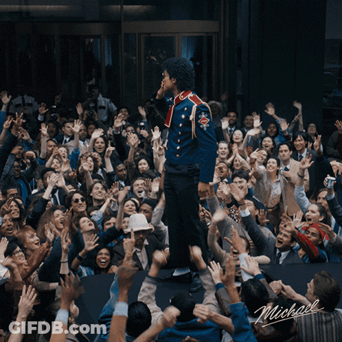 Man In Blue Uniform Standing Before Crowd With Name Michael GIF