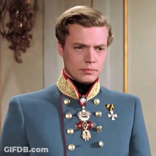 Man In Blue Uniform With Medal And Cross GIF