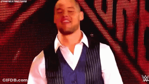 Man In Blue Vest And White Shirt On Red Background GIF