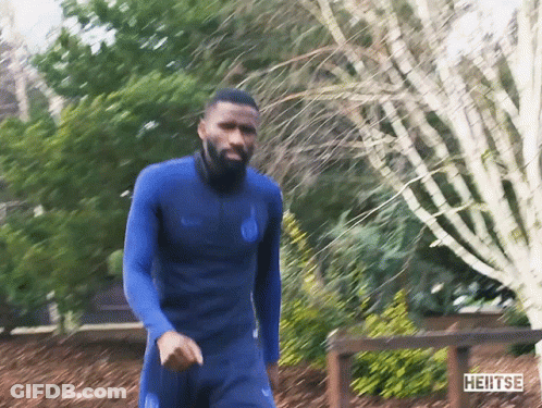 Man In Blue Wetsuit Walking Past Heitse Sign GIF