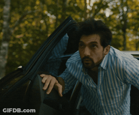 Man In Blue White Striped Shirt Looking Out Car Window GIF