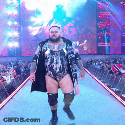 Man In Bodysuit Walking Runway With Big Creed Screen GIF