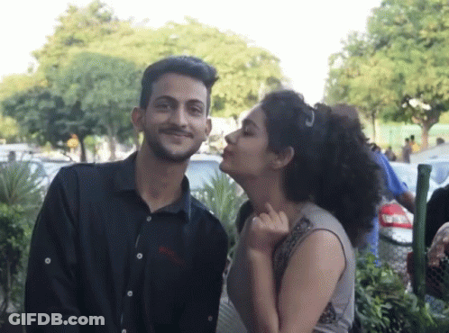 Man In Boss Shirt Standing Next To Woman GIF