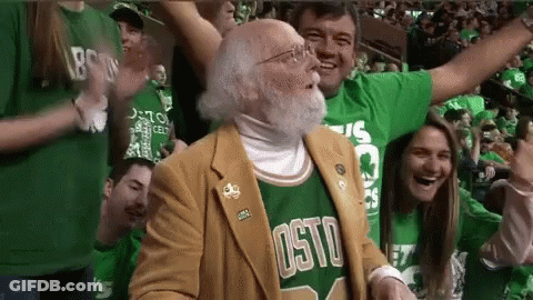 Man In Boston Jersey Stands In Crowd Of Fans GIF