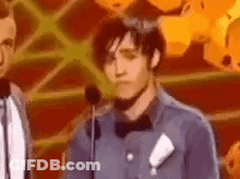 Man In Bow Tie Making Face At Microphone GIF