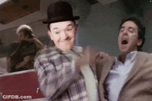 Man In Bowler Hat Next To Man In Suit GIF