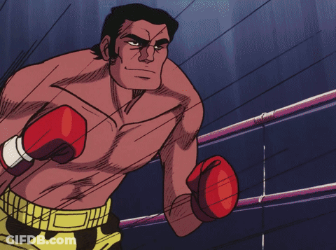 Man In Boxing Gloves And Yellow Shorts Standing In Ring GIF