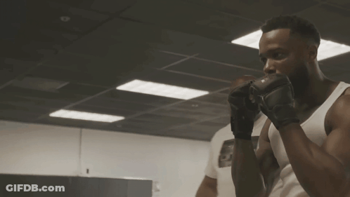 Man In Boxing Gloves In Dark Room GIF