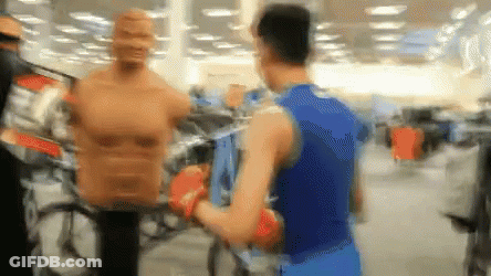 Man In Boxing Gloves In Store GIF