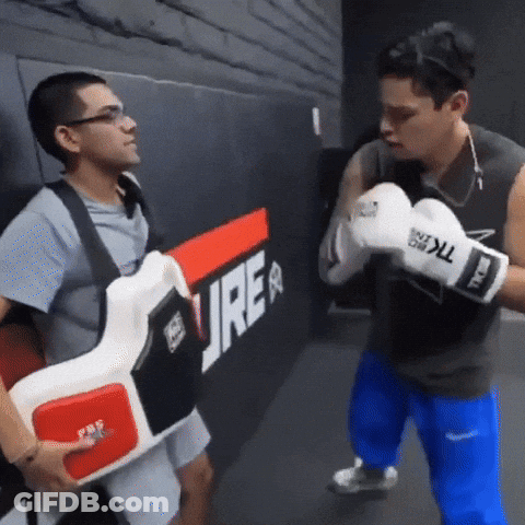 Man In Boxing Gloves Next To Man With Vest Saying Ure GIF