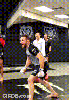 Man In Boxing Gloves Running On Gym Mat GIF