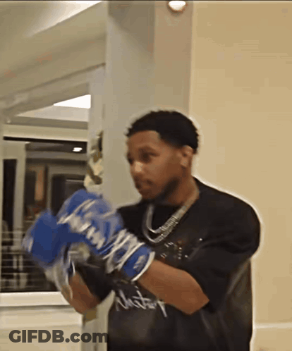 Man In Boxing Gloves With Victory Shirt GIF