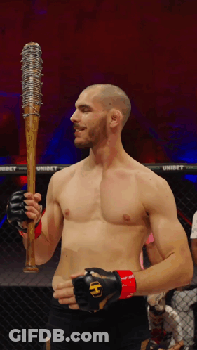 Man In Boxing Ring Holding Spiked Baseball Bat GIF