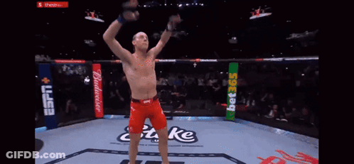 Man In Boxing Ring With Arms Up Saying Take GIF