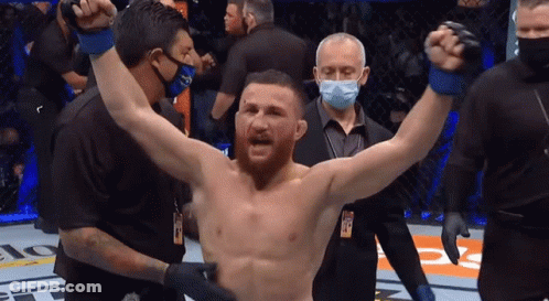 Man In Boxing Ring With Hands In Air GIF