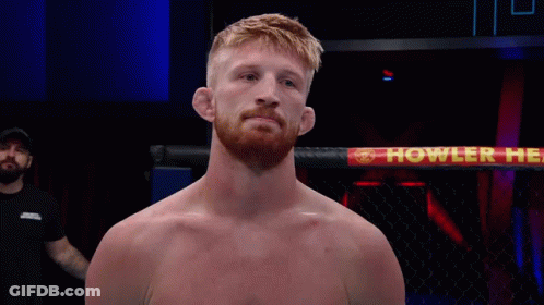 Man In Boxing Ring With Howler Sign GIF