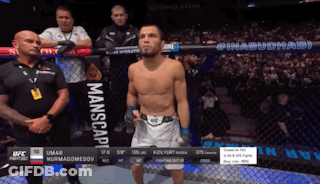Man In Boxing Ring With Manscape Sign GIF