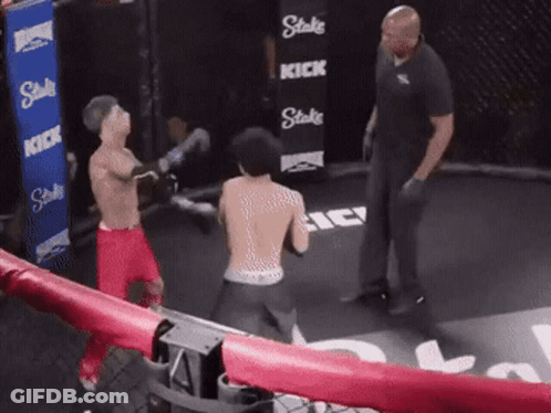 Man In Boxing Ring With Stake Kick Sign GIF