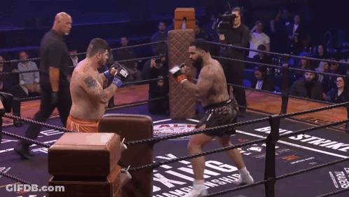 Man In Boxing Ring With Word Skin On Ground GIF