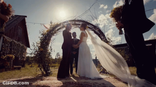 Man In Bride's Dress Looking In Mirror GIF