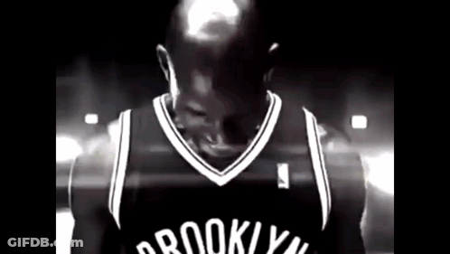 Man In Brooklyn Nets Jersey In Dark Room GIF