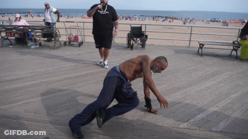 Man In Brooklyn Shirt Next To Man In Wheelchair GIF