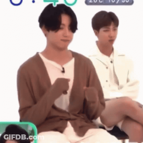 Man In Brown Cardigan Sitting GIF