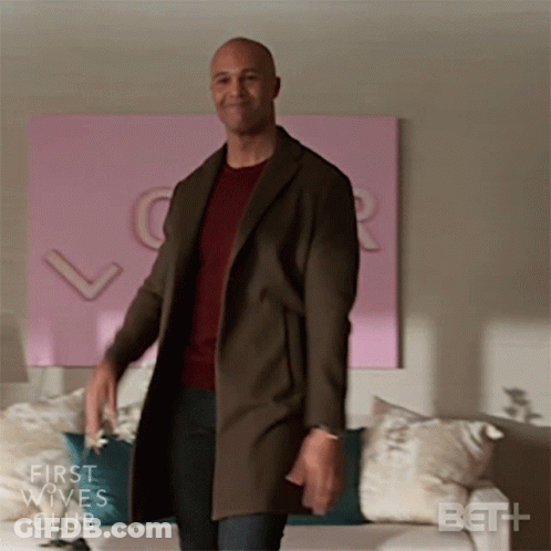 Man In Brown Coat In Front Of Couch First Wives Club GIF
