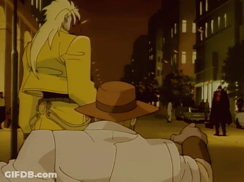 Man In Brown Hat Next To Man In Yellow Jacket GIF