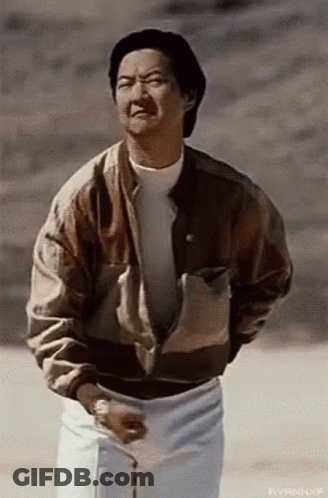 Man In Brown Jacket And White Shorts In Field GIF