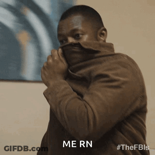 Man In Brown Jacket Covering Face With Jacket Saying Mern GIF
