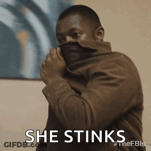 Man In Brown Jacket Covering Face GIF