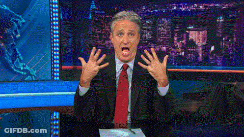 Man In Brown Jacket Holding Green Light GIF
