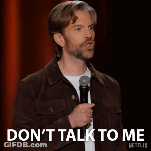 Man In Brown Jacket Holding Microphone Says Don't Talk To Me GIF