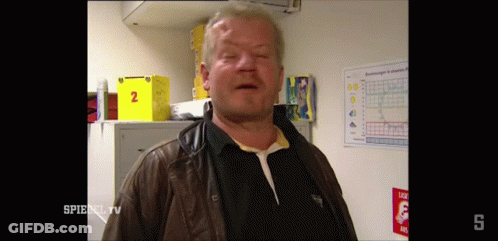 Man In Brown Jacket In Front Of Spiegel Sign GIF