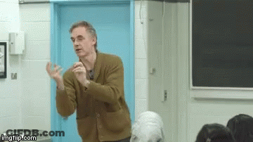 Man In Brown Jacket Lecturing At Blue Door GIF