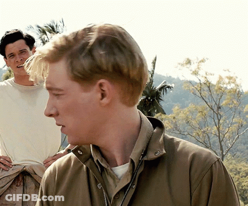Man In Brown Jacket Looking Side With Man Behind GIF