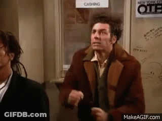 Man In Brown Jacket Next To Man In Black Suit GIF