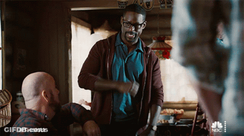 Man In Brown Jacket Next To Man In Blue Shirt GIF