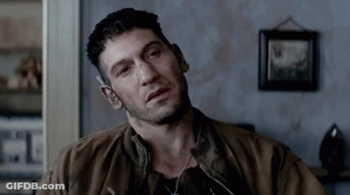Man In Brown Jacket Sitting In Living Room GIF